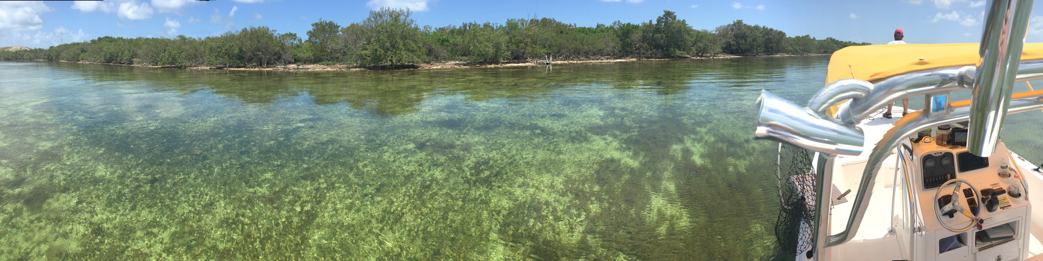 Clear shallow Florida grass flats beside a small boat during scallop season